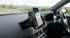 Air vent mounted fast wireless charging car mount holding a smartphone firmly in place inside a car.