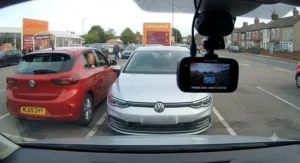 A dash cam with parking mode recording an incident in a UK supermarket car park to provide evidence of damage.
