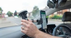 Quick-release windscreen phone mount being installed on a car windscreen.