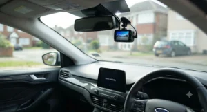 A finished dash cam installation in a UK vehicle showing the camera automatically powering on with the ignition.