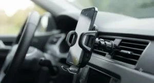 A universal air vent mobile phone holder featuring adjustable grip arms for various smartphone sizes.