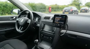 A universal DAB radio adapter for car audio systems showing digital station tuning.