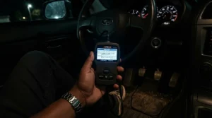 Clear LCD screen on a budget OBD2 scanner displaying engine fault codes for British motorists.