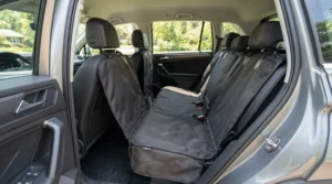 A durable dog seat cover for car installed across the rear bench of a family saloon