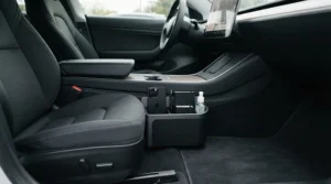 Driver side view of a black car seat gap filler providing extra front seat storage for daily commuting essentials