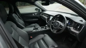 A parked car interior kept cool and shaded by a silver windscreen sunshade for car.
